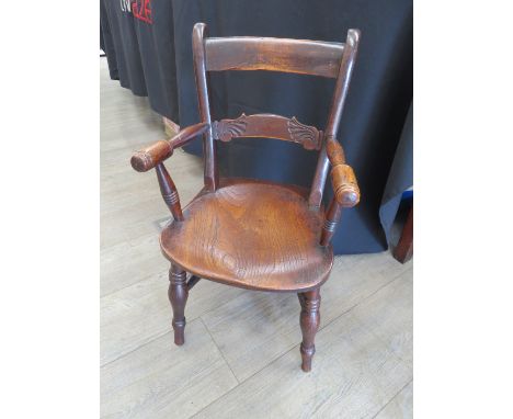 A Circa 1850 East Anglian elm and ash child's knife back armchair carved cross rail the turned arms over a saddle seat on rin