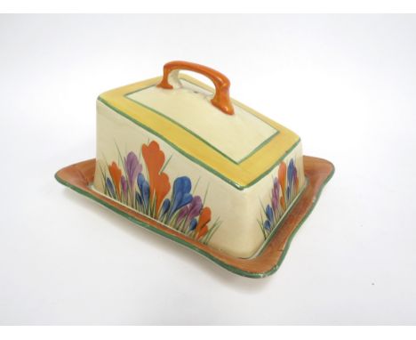 A Clarice Cliff Crocus pattern cheese dome and cover. (chip and hairline to cover, staining to dish) 