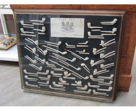 EDWARD POLLOCK; A large framed display of clay pipes by Central Clay Pipe Works, Manchester EST. 1879, 83cm x 98cm 