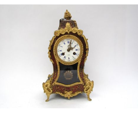 A Henry Marc of Paris Boullework mantel clock with gilt metal mounts and mask detail, Roman numerated dial, 30.5cm tall 