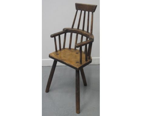 RARE 19TH CENTURY WELSH PRIMITIVE ASH AND ELM FIRESIDE CHILD'S ARMCHAIR with comb back, moulded seat, on three turned, taperi