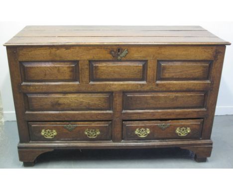 18TH CENTURY WELSH OAK MULE CHEST, having planked moulded edge, hinged top, over front with an arrangement of five raised and