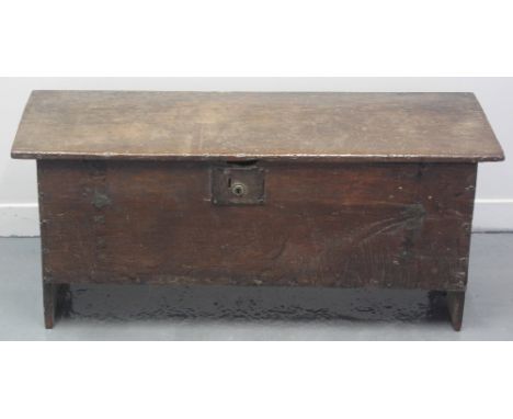 17TH CENTURY PRIMITIVE OAK PLANK CHEST OR COFFER having a hinged top, standing on end supports.  107 x 38 x 47cm.(B.P. 24% in