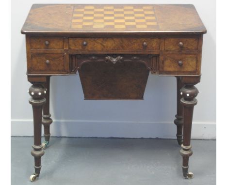 VICTORIAN WALNUT GAMES AND SEWING TABLE, having chequer board inlaid top above arrangement of five drawers around moulded kne