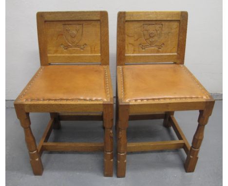 PAIR OF 'ROBERT MOUSEMAN' THOMPSON OAK HALL CHAIRS with panelled backs, having armorial shields and text: 'Mea Gloria Fides',