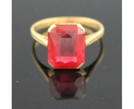 18CT GOLD AND SYNTHETIC RUBY RING.  The step cut stone in claw mount.  Ring size K & 1/2.  French marks.(B.P. 24% incl. VAT)