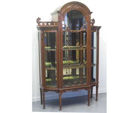 EARLY 20TH CENTURY WALNUT DISPLAY CABINET, having arch glazed centre door flanked by two curved and glazed angles, fitted she