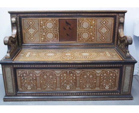 19TH CENTURY MOORISH HARDWOOD AND EBONISED SETTLE, overall copiously inlaid in ivory with foliate and geometric designs, and 