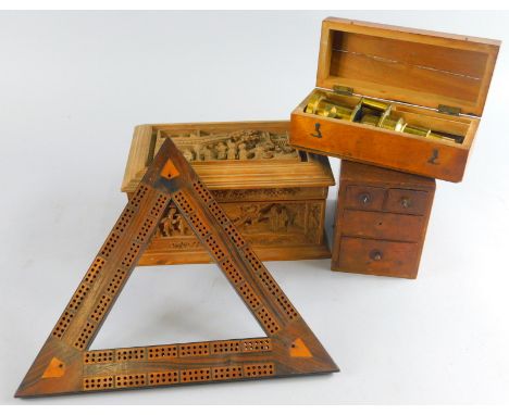 A heavily carved wooden casket, various other bygones, collectables, triangular cribbage board, table top casket with content