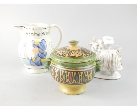 A reproduction Admiral Nelson and Captain Hardy relief moulded jug, a Continental pottery jar and cover and a Studio candlest