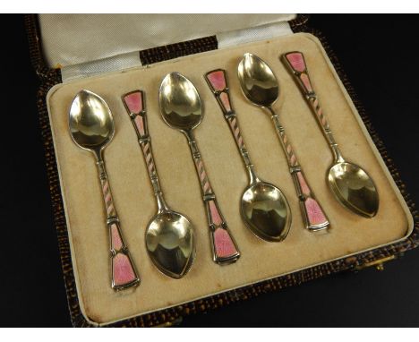 A set of six George VI silver gilt and pink enamel Art Deco style coffee spoons, in a fitted case, Birmingham 1950.