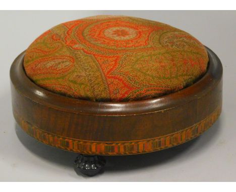 A Victorian walnut and parquetry footstool, on black surround, ceramic feet, 29cm diameter. 