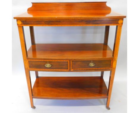An Edwardian and satinwood crossbanded three tier whatnot, with a raised back above bow fronted shelves, on square tapering l