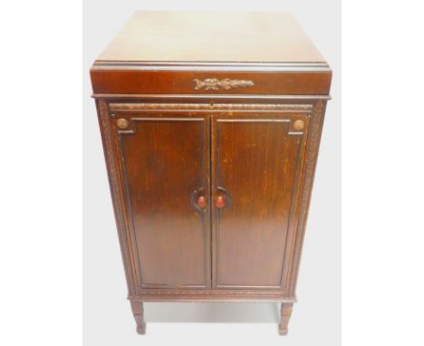 An early to mid 20thC mahogany gramophone, the hinged lid enclosing chrome fittings, stamped Salon Decca, above two panelled 
