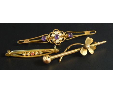 Three stick pins, to include a Victorian amethyst and seed pearl bar brooch, yellow metal, unmarked, and two gold plated bar 