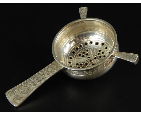 A George V silver tea strainer, engraved overall with a Celtic style design, with angular handles etc., Birmingham 1913, 2½oz
