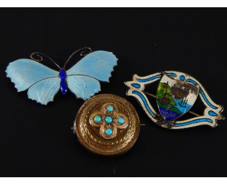 A silver and white enamel butterfly brooch, a sterling and enamel brooch and a Victorian gilt metal and turquoise brooch (3)