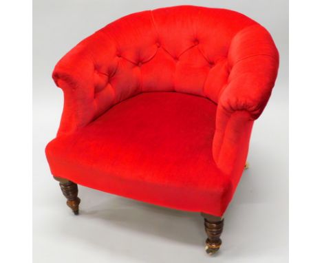 A late Victorian walnut tub shaped chair, upholstered in red buttoned fabric, on turned legs, with ceramic castors. 