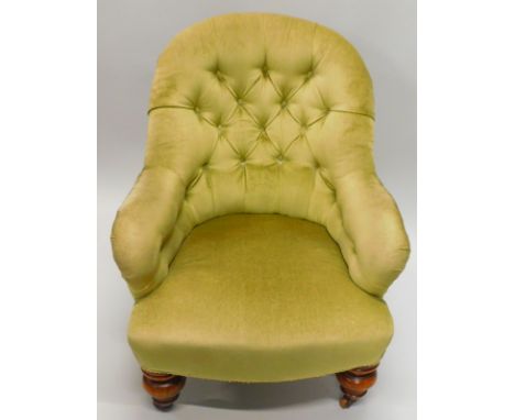 A Victorian mahogany armchair, upholstered in green buttoned fabric, on bulbous turned legs, and ceramic castors. 