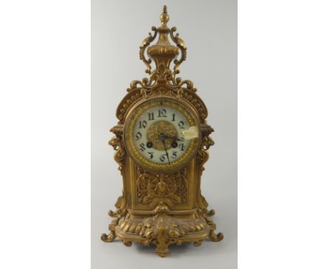 A French gilt metal rococo style mantel clock, with a white enamel insert to the dial, 38cm high