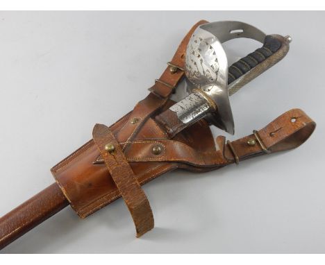 A George V dress sword, with engraved blade, leather scabbard, and a holster stamped Lieutenant J.H. Robertson of the Lincoln