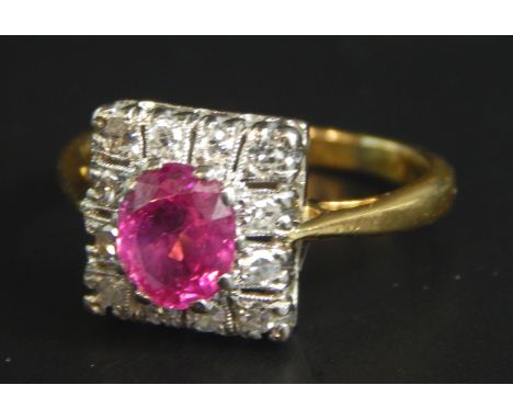 An Art Deco dress ring, set with central ruby, surrounded by tiny diamonds, on yellow metal band, unmarked, 3.6g all in, boxe