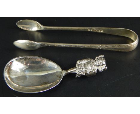 Two silver items, a tea caddy spoon with Lincoln Imp handle and a pair of sugar tongs, 1¼oz overall
