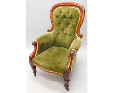 A Victorian mahogany showframe chair, with a button padded back, padded seat and arms on scroll carved arm supports, with cer