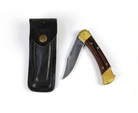 A buck 110 folding pocketknife, with a 3 3/4" blade, 22 cm overall with leather pouch.  This bladed product is not for sale t
