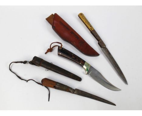 Three hunting knives, a Winchester Comanche fixed blade with a 4 1/2" blade with sheath, a folding Spanish knife with bone ha