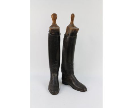 A pair of gentleman's black leather hunting boots, with wooden shoe trees marked Tom Hill London SW1 Knightsbridge.