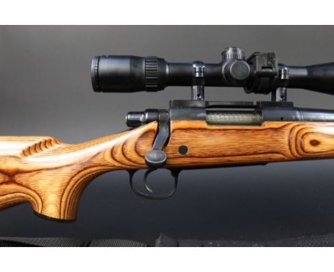 A Remington Model 700 cal 223 bolt action rifle, with a heavyweight bull barrel, laminate stock, T8 sound moderator and fitte