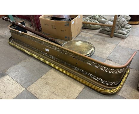A Victorian pierced brass fender and a warming pan 