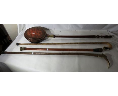 3 walking sticks 2 with horn handles and 1 with a silver band, and a Victorian copper bed warming pan