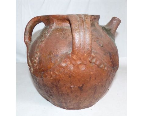A large and impressive medieval earthenware three-handled vessel with pouring spout, c. 1500. It has simple applied and geome