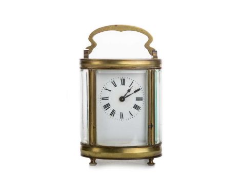 BRASS OVAL CARRIAGE CLOCK, CIRCA 1913 with single train movement, the five glass case with dated presentation inscription, sw