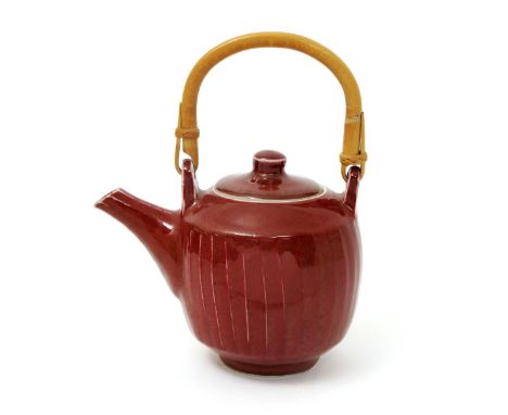 ‡ David Leach OBE (1911-2005) a Lowerdown Pottery cut-sided porcelain teapot and cover, covered in a reduced copper red glaze