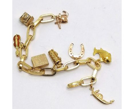 18ct gold charm bracelet with 8 charms i) 9ct faith/hope/charity ii) 9ct Chim opening well iii) 18ct enamel guitar iv) 9ct Ho