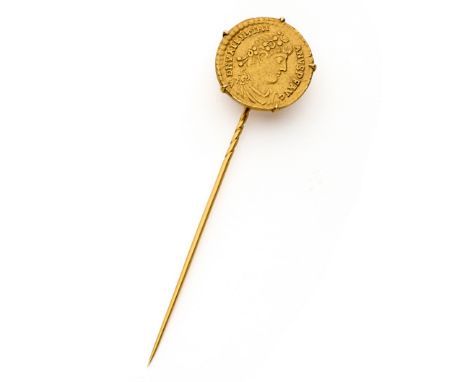 A GOLD STICK PIN SET WITH A ROMAN EMPEROR VALENTIAN I GOLD SOLIDUS the pin surmounted by a five-claw ring holding the 367-375