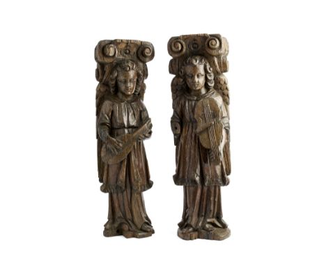 A PAIR OF OAK ARCHITECTURAL ELEMENTS CARVED AS ANGELS, FLEMISH, 17TH CENTURY the winged figures carved as one playing a lute,