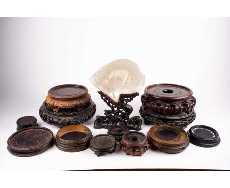 A collection of twelve Chinese carved wood vase stands, principally 19th century, 8cm - 24cm diameter and a blank mother of p