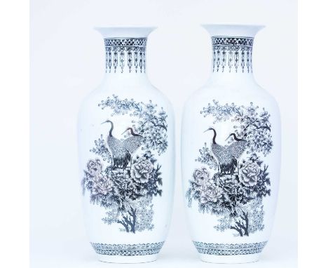 A pair of Chinese Peoples Republic porcelain vases, 20th century, the flared rim above a black stencilled pendant drop neck, 