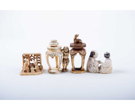 Three Japanese ivory okimono and a netsuke, Meiji/Taisho, comprising a fortune teller reading a clients palm, signed, two sch