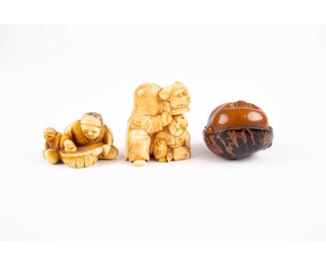 Two Japanese netsuke and an okimono, Meiji/Taisho period, comprising a Koroso nut carved as Hyottoko, signed, an ivory netduk