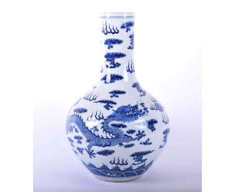 A Chinese blue and white dragon tianqiuping vase,decorated with a flaming pearl flanked by opposing dragons amongst clouds wi