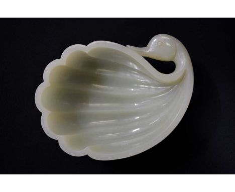 A fine white jade brush washer, 18th century, in the form of a duck, its head turned backwards towards its six feather lobes 