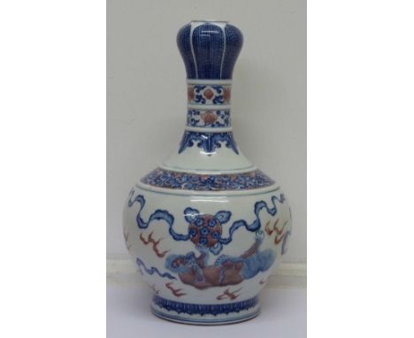 A fine Chinese mallet shaped garlic lipped vase, well painted in blue with playful Buddhist lions chasing ribbon-tied brocade