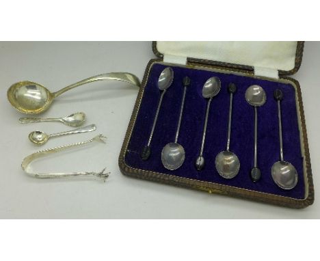 A set of six silver coffee bean spoons, a silver ladle, a pair of sugar bows and two spoons, weight 80g