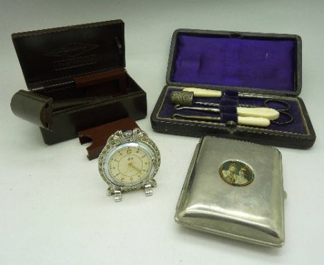A Bakelite Gillette razor with case, a cased sewing set, a commemorative cigarette case and a small Smiths clock