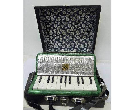 A small sixteen button accordion, made in USSR, cased